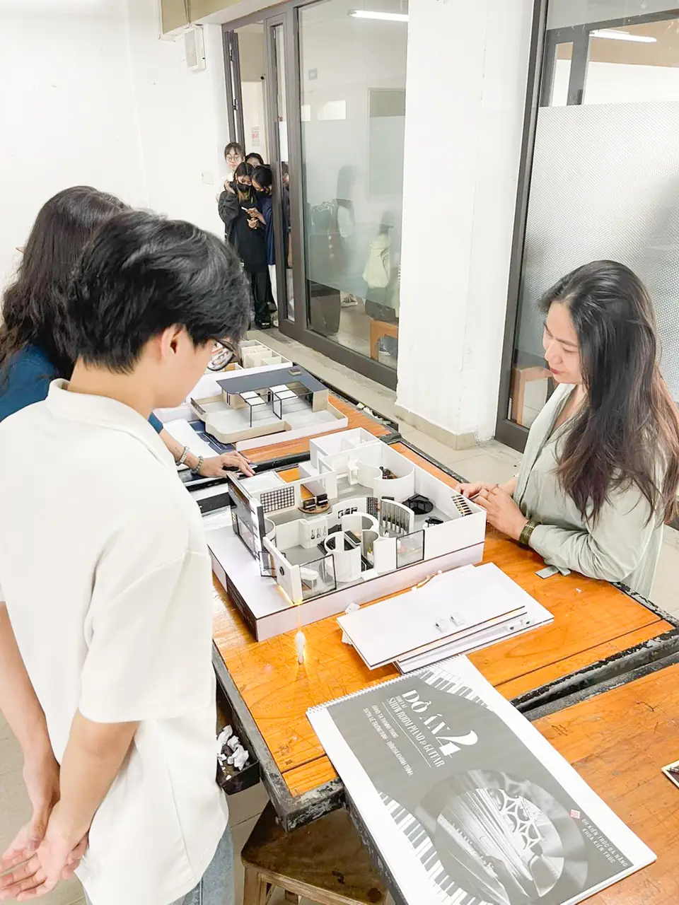 Giảng viên xem mô hình nội thất showroom của sinh viên